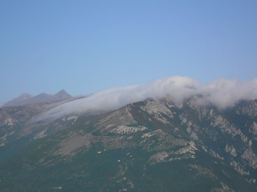 Le nuvole non sono riuscite a risalire le cime più elevate delle Liguri: dopo aver scavalcato il crinale nei pressi del Galero, colano in Valle Pennavaira dissolvendosi lungo la discesa